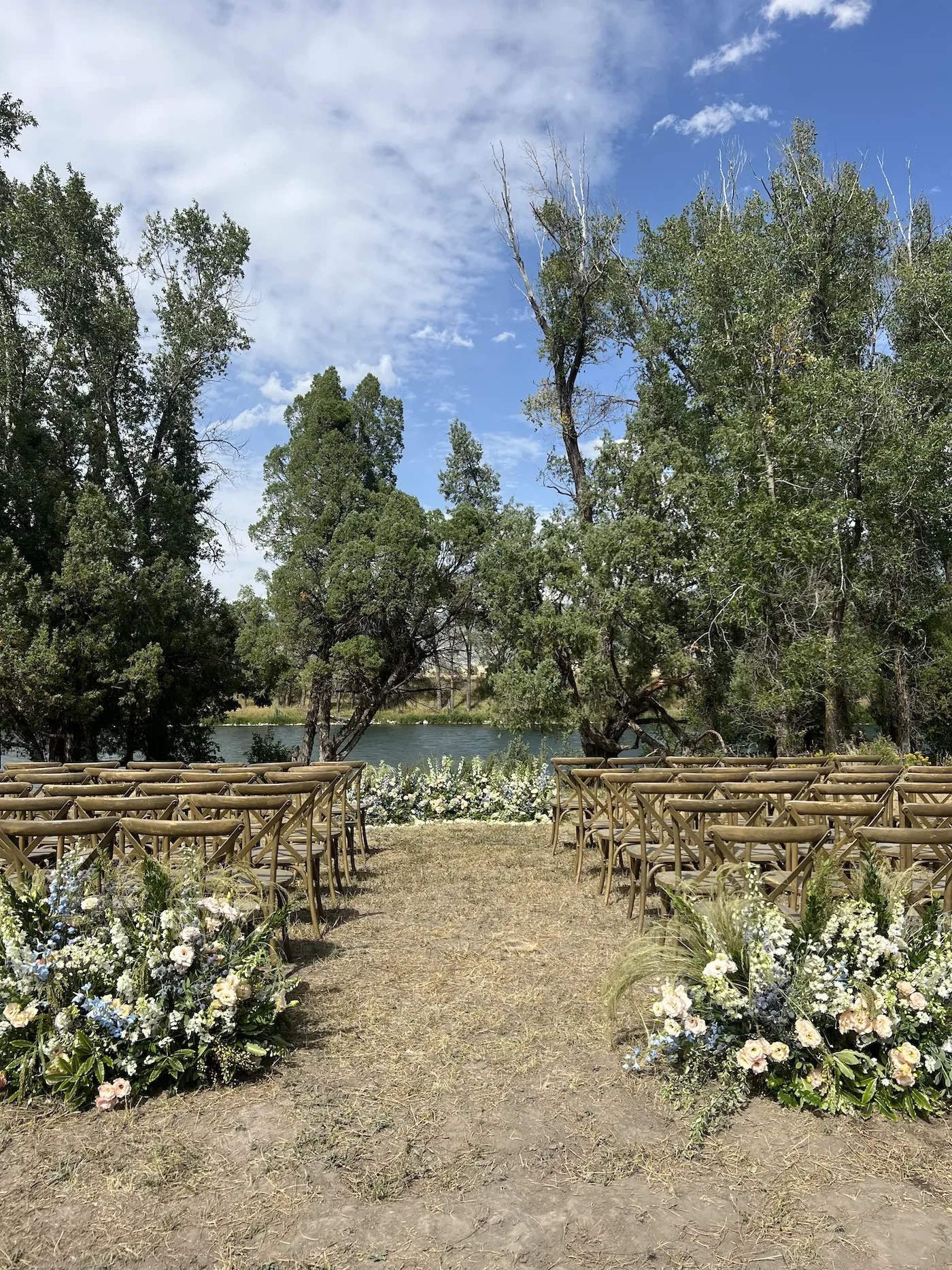 Riverside ceremony aisle lined with garden flowers