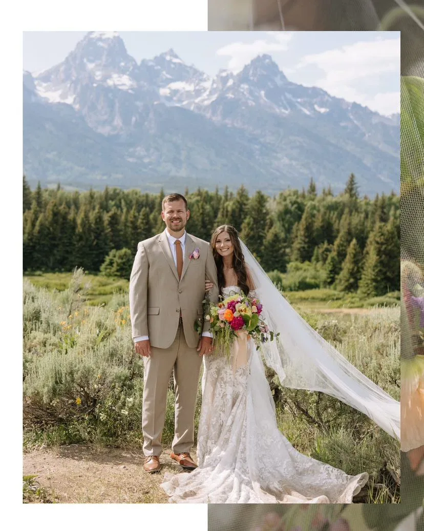 Couple in a meadow, the bride holding a colorful garden bouquet with the Tetons behind them