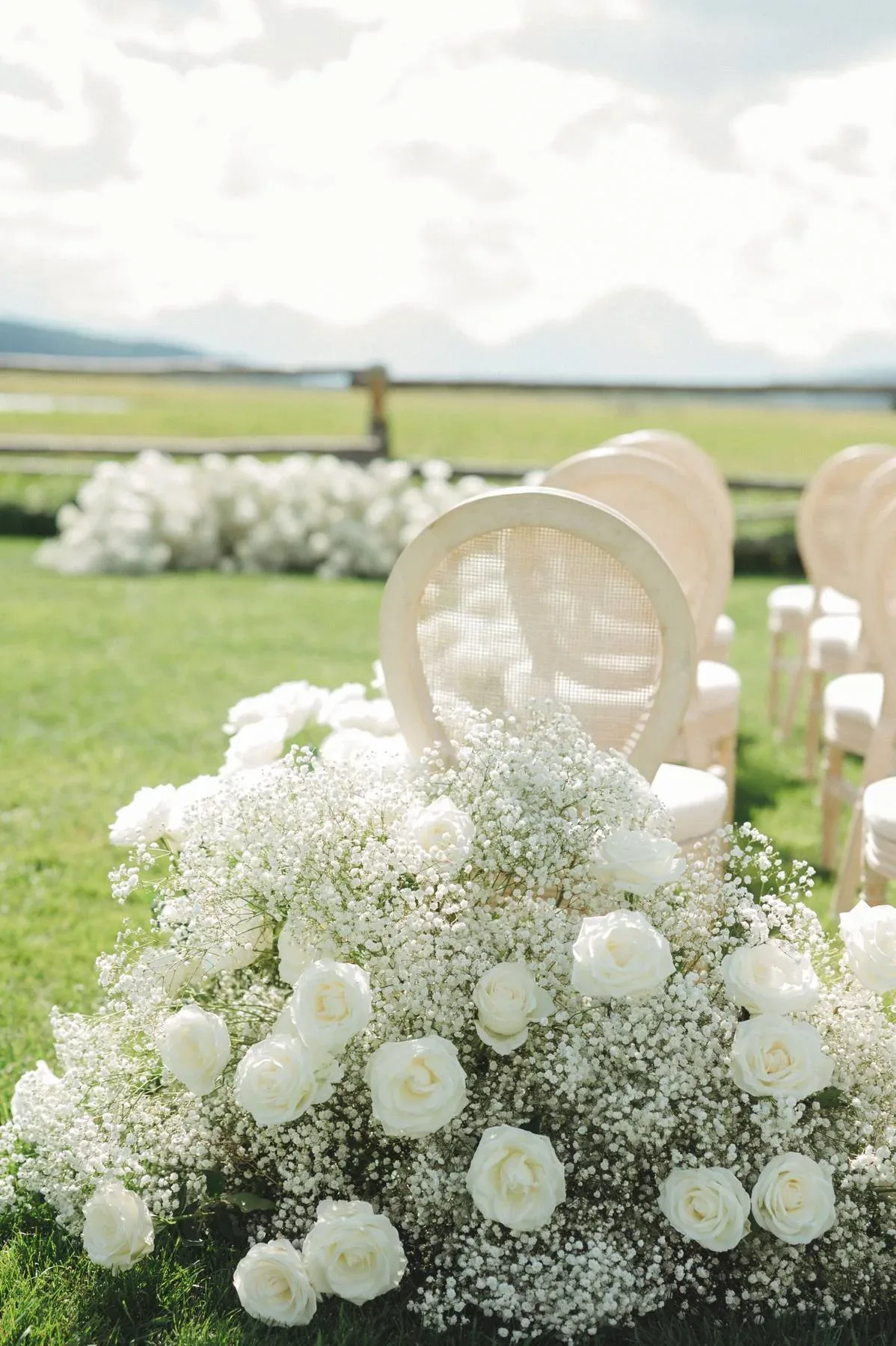 White rose and baby’s breath aisle arrangement