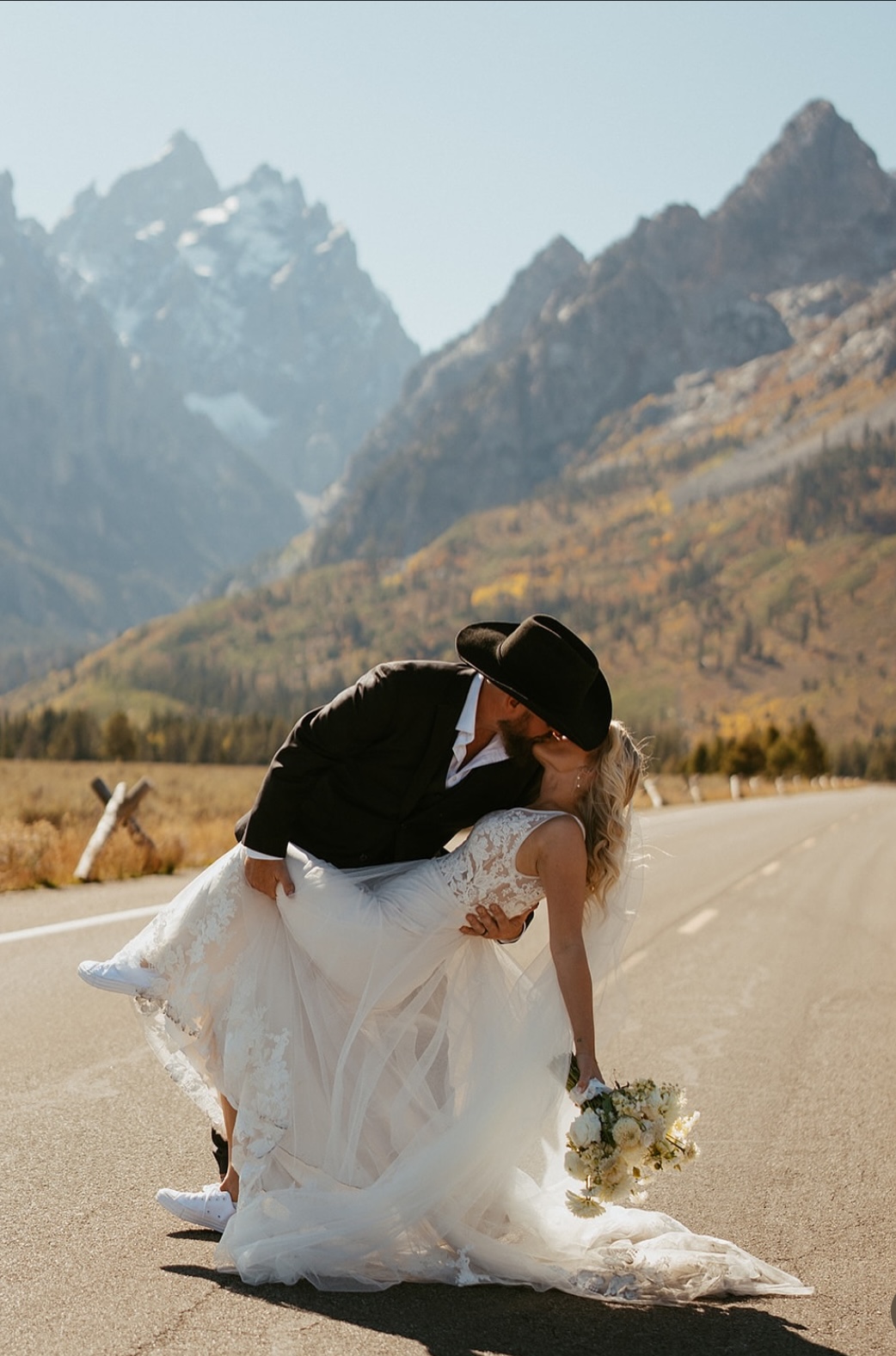 bride and groom kissing near the teton national park